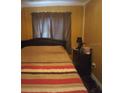 Cozy bedroom with striped bedding and a nightstand at 11390 E Irlo Bronson Memorial Hwy, St Cloud, FL 34773