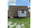 Rear view of A-frame home showing a shed-like structure at 11390 E Irlo Bronson Memorial Hwy, Saint Cloud, FL 34773