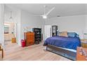 Bright bedroom with hardwood floors, a large bed, and built-in shelving at 1967 Long Boat Dr, Lakeland, FL 33810