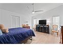 Spacious bedroom with light wood floors, a ceiling fan, and plenty of natural light at 1967 Long Boat Dr, Lakeland, FL 33810