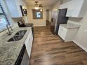 Kitchen with granite countertops and stainless steel appliances at 1911 High St, Leesburg, FL 34748