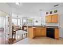 Open kitchen with light wood cabinets, stainless steel appliances, and breakfast bar at 612 Terrace Ridge Cir # 612, Davenport, FL 33896