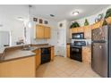 Bright kitchen with wood cabinets, stainless steel appliances, and tile floor at 612 Terrace Ridge Cir # 612, Davenport, FL 33896