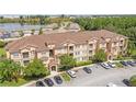 Exterior condo building view, featuring ample parking and lake views at 612 Terrace Ridge Cir # 612, Davenport, FL 33896