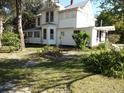 Two-story white house with wrap around porch at 207 E 2Nd Ave, Pierson, FL 32180