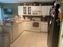 L-shaped kitchen with white cabinets and standard appliances at 6131 Sabal Point Cir, Port Orange, FL 32128
