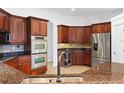 Gourmet kitchen with stainless steel appliances and granite countertops at 5994 Seminole Woods Dr, Port Orange, FL 32127