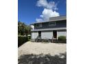 Exterior of building with gravel parking area at 2329 River Ridge Rd # 160, Deland, FL 32720