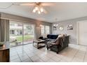 Living room with tiled floors and sliding doors at 2801 N Halifax Ave # 143, Daytona Beach, FL 32118