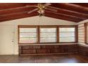 Spacious living room featuring wood ceiling and built-in shelving at 150 E Washington Ave, Lake Helen, FL 32744