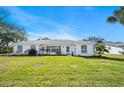 Single-story home with white exterior and green lawn at 36 Dresden Cir, Ormond Beach, FL 32174