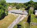 Aerial view of a single-story house with a large yard and driveway at 1625 Old Daytona Rd, Deland, FL 32724