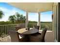Private balcony with outdoor seating and scenic views at 4672 Riverwalk Village Ct # 8201, Ponce Inlet, FL 32127