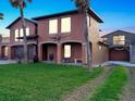 Two story house with large garage, palm trees, and ocean view at 3580 Ocean Shore Blvd, Ormond Beach, FL 32176