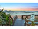 Wooden boardwalk leads to sandy beach with ocean view at 3580 Ocean Shore Blvd, Ormond Beach, FL 32176