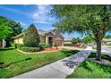 House exterior with stone accents and a paved driveway at 605 Champions Gate, Deland, FL 32724