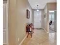 Bright entryway with tile flooring and a drop leaf table at 605 Champions Gate, Deland, FL 32724