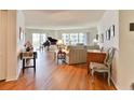 Living room with hardwood floors, piano, and couch at 3 Oceans West Blvd # 5C4, Daytona Beach Shores, FL 32118