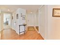 Entryway with wood floors, small table and mirror at 3 Oceans West Blvd # 5C4, Daytona Beach Shores, FL 32118