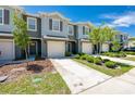 Modern townhouses with attached garages and landscaping at 28 Bella Lago Cir, Port Orange, FL 32129