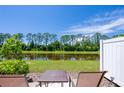 Relaxing patio overlooking a pond with seating at 28 Bella Lago Cir, Port Orange, FL 32129