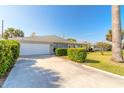 House exterior showcasing a driveway, garage, and well-maintained lawn at 100 Talo Cir, Port Orange, FL 32127
