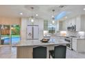 Updated kitchen with granite island and stainless steel appliances at 3 Wisteria Dr, Ormond Beach, FL 32176