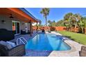 Relaxing pool with patio furniture and wooden accents at 3 Wisteria Dr, Ormond Beach, FL 32176