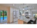 Updated kitchen with granite island and stainless steel appliances at 3 Wisteria Dr, Ormond Beach, FL 32176