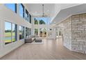Spacious living area with high ceilings and stone feature wall at 1978 Country Club Dr, Port Orange, FL 32128
