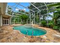 Inviting pool area with screened enclosure, fountain, and spacious patio at 3 Broadriver Rd, Ormond Beach, FL 32174