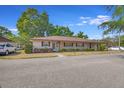 Tan house with maroon shutters and landscaping at 41 Villa Villar Ct # 41, Deland, FL 32724