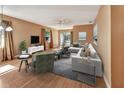 Bright living room with hardwood floors and neutral walls, featuring a comfy sectional sofa and large windows at 41 Villa Villar Ct # 41, Deland, FL 32724