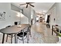 Open concept dining area with tile floors and modern light fixtures at 13 S University Cir, Deland, FL 32724