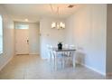 Bright dining room features a table with four chairs and a modern chandelier at 226 Meghan Cir, Deland, FL 32724
