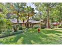 Lovely home with mature trees and landscaping, creating a serene atmosphere at 121 Willow Bend Ln, Ormond Beach, FL 32174