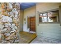 Inviting front entrance with a stone accent wall and wooden door at 121 Willow Bend Ln, Ormond Beach, FL 32174