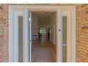 Open front door leads into a spacious home with high ceilings and tile floors at 1839 Spruce Creek Blvd, Port Orange, FL 32128