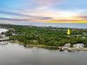 Aerial view of waterfront property with sunset view at 110 Ocean Way Dr, Ponce Inlet, FL 32127