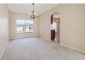 Dining room with a chandelier and a view into the kitchen at 196 Athabasca Dr, Poinciana, FL 34759