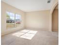 Bright and spacious living room with large windows and neutral-colored carpet at 196 Athabasca Dr, Poinciana, FL 34759
