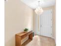 Bright entryway with a modern chandelier and wooden console table at 509 W Victoria Trails Blvd, Deland, FL 32724