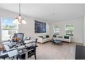 Bright living room with white couches and a large art piece at 968 Springs Landing Dr, Deltona, FL 32725