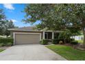 One-story house with attached garage and landscaping at 968 Springs Landing Dr, Deltona, FL 32725