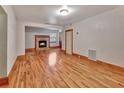 Spacious living room featuring hardwood floors, a brick fireplace, and ample natural light at 2652 N Woodland Blvd, Deland, FL 32720