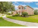 Two story house with brick driveway and landscaped yard at 206 Laurel Point Ct, Deland, FL 32724