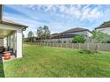 Fenced backyard with lush green grass at 2550 Cedar Shake Ct, Oviedo, FL 32765