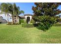 House with lush landscaping and palm trees at 2273 Grayling St, Orlando, FL 32820