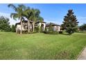 Landscaped front yard with lush grass and palm trees at 2273 Grayling St, Orlando, FL 32820