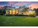 Beautiful home exterior with lush landscaping at sunset at 2075 Country Farms Rd, Port Orange, FL 32128